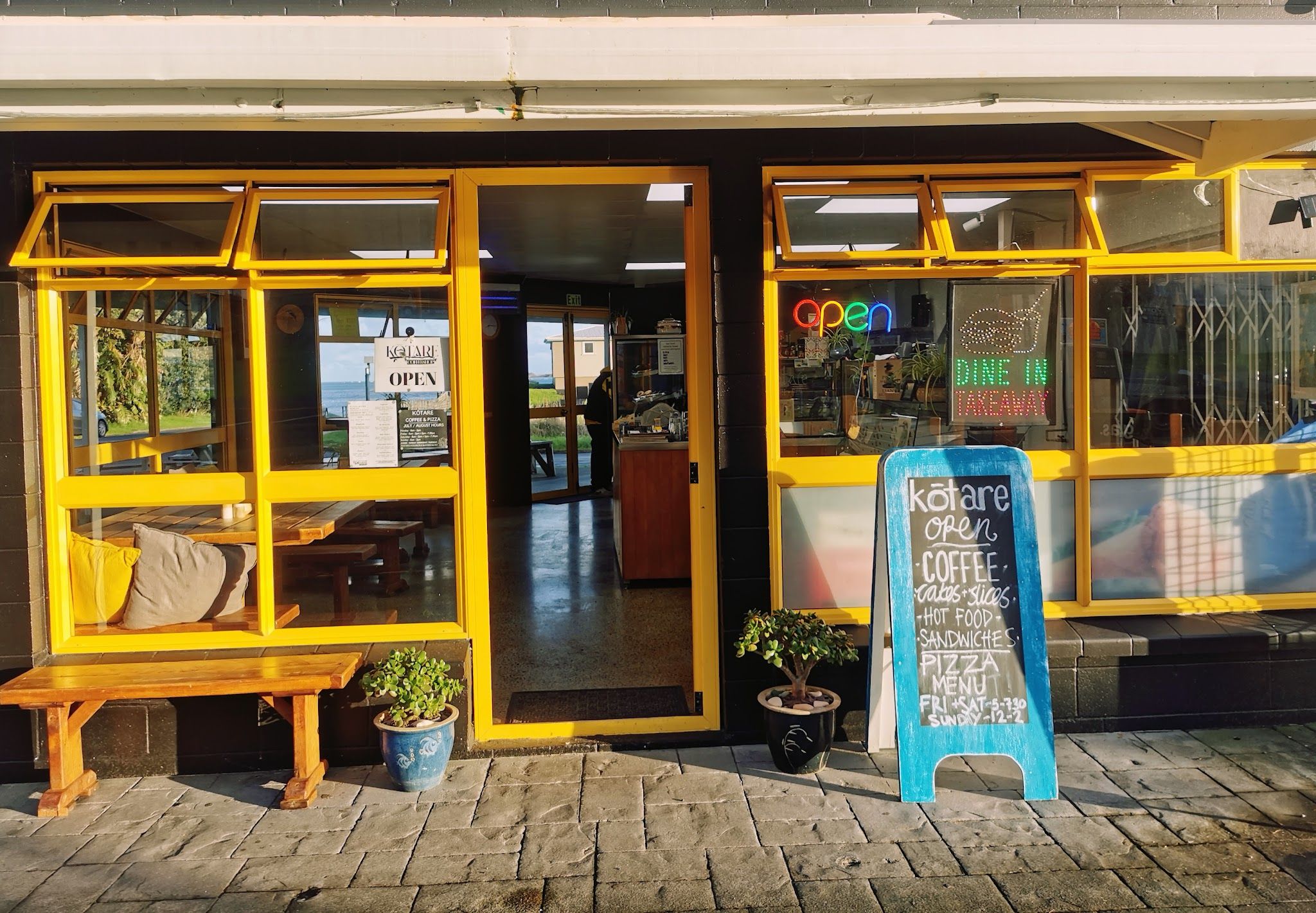 Manu café exterior — yellow-framed converted garage on State Highway 12